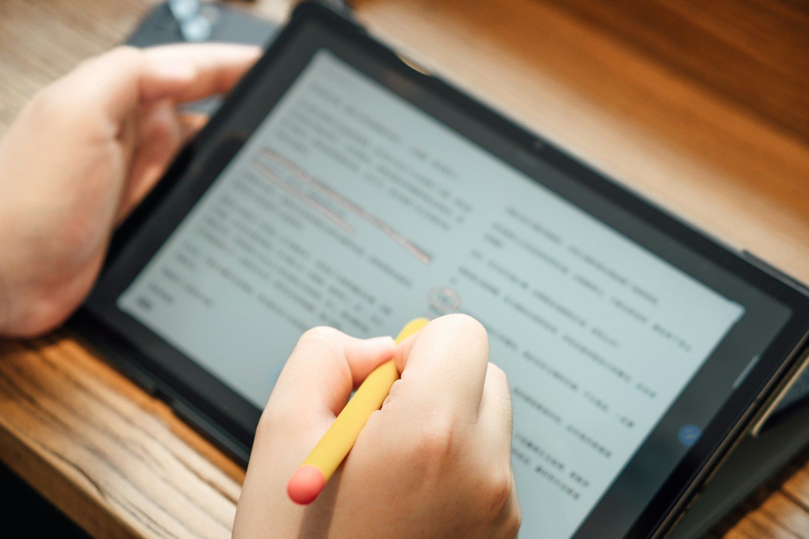 Photo by Shawn Rain a person writing on a tablet