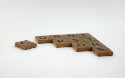 Photo by Brett Jordan scrabble tiles spelling the word corona on a white background