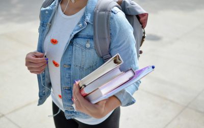 Photo by Element5 Digital woman wearing blue denim jacket holding book